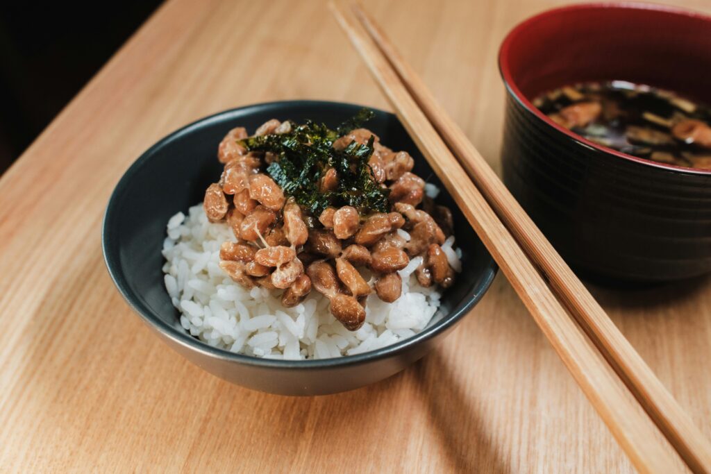 pexels-photo-30874702-30874702 Close-up of traditional Japanese breakfast with natto and rice, a healthy fermented soybean dish.