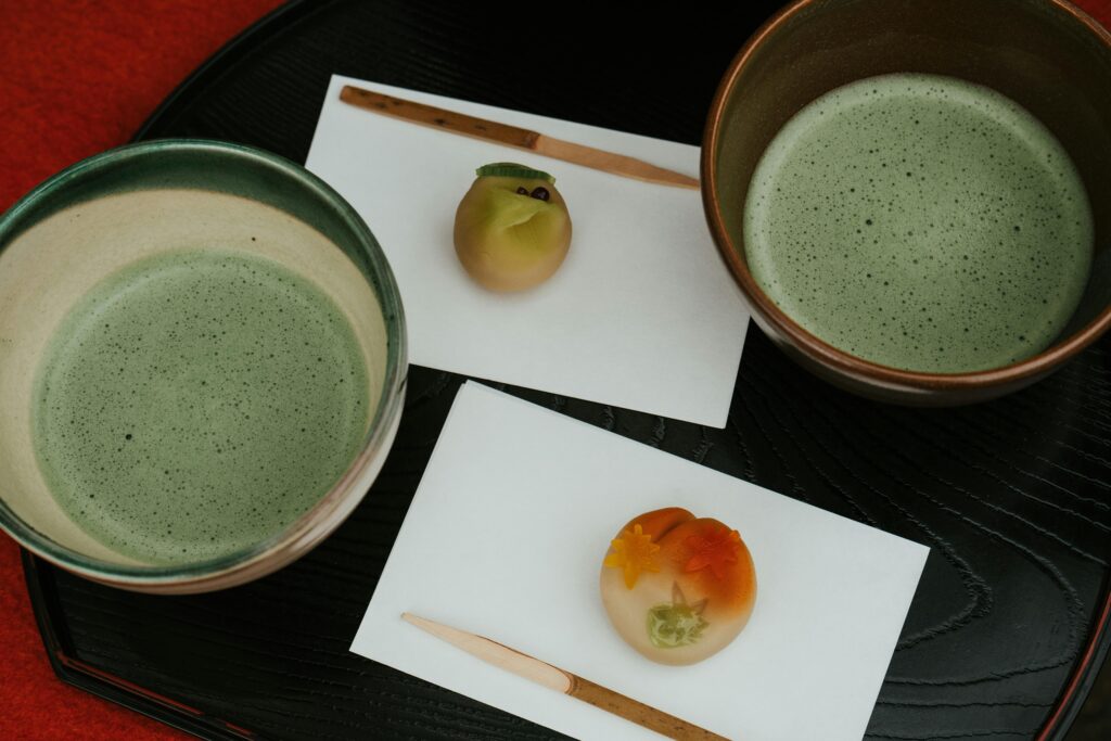 pexels-photo-29518256-29518256 Artistic presentation of matcha tea and wagashi sweets in a traditional Japanese tea ceremony setting.