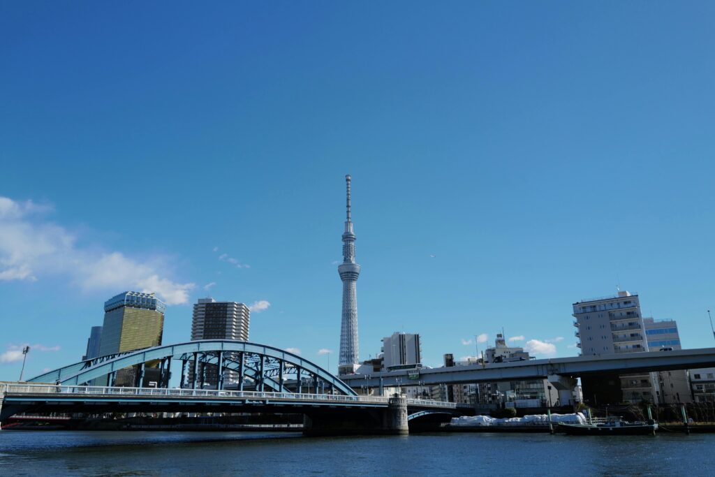 pexels-photo-31374573-31374573 A serene view of Tokyo Skytree and Sumida River under a clear blue sky.